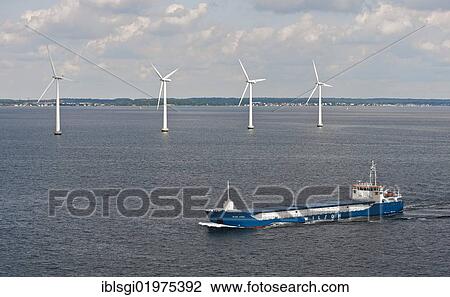 Cargo ship "Wilson Astakos" sailing in front of an offshore wind farm in the Øresund outside Copenhagen, Denmark, Europe View Large Photo Image Stock Image - Cargo ship "Wilson Astakos" sailing in front of an offshore wind farm in the Øresund outside Copenhagen, Denmark, Europe. Fotosearch