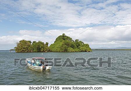 Cayo or rock island, frigate birds circle above, motor boats in front and behind, Los Haitises National Park, Samaná Province, Dominican Republic, Central America View Large Photo Image Stock Photography - Cayo or rock island, frigate birds circle above, motor boats in front and behind, Los Haitises National Park, Samaná Province, Dominican Republic, Central America. Fotosearch