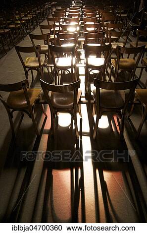 Stock Image - Chairs in a row with shaddows. Fotosearch