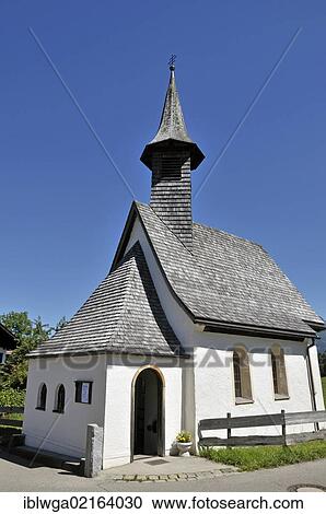 Stock Image - Chapel of St. Fabian and St. Sebastian, with a shingle gabled roof with a high-reaching spire, built in the 16th Century, district of Kornau, Oberstdorf, Upper Allgaeu, Bavaria, Germany, Europe, PublicGround, Europe. Fotosearch