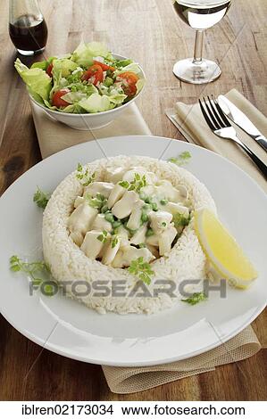Picture - Chicken fricassee with asparagus, peas and mushrooms in a ring of rice, salad, Worcestershire sauce, white wine. Fotosearch
