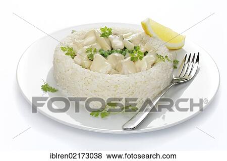 Stock Photo - Chicken fricassee with asparagus, peas and mushrooms in a ring of rice. Fotosearch