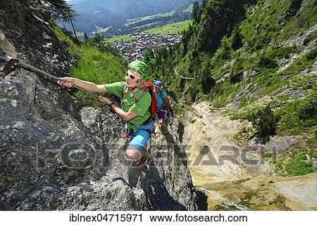 Climbers at rock face, via ferrata Hausbachfall, Reit im Winkl, Chiemgau, Bavaria, Germany, Europe View Large Photo Image Stock Image - Climbers at rock face, via ferrata Hausbachfall, Reit im Winkl, Chiemgau, Bavaria, Germany, Europe. Fotosearch