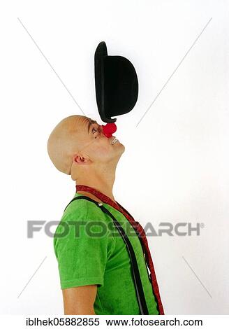 Clown balances hat on nose, Berlin, Germany, Europe View Large Photo Image Stock Photography - Clown balances hat on nose, Berlin, Germany, Europe. Fotosearch