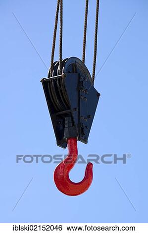 Stock Photograph - Crane hook against a blue sky in Lisbon, Portugal, Europe. Fotosearch