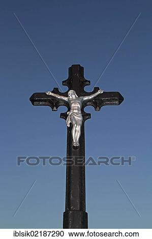 Stock Image - Crucifix against a blue sky. Fotosearch
