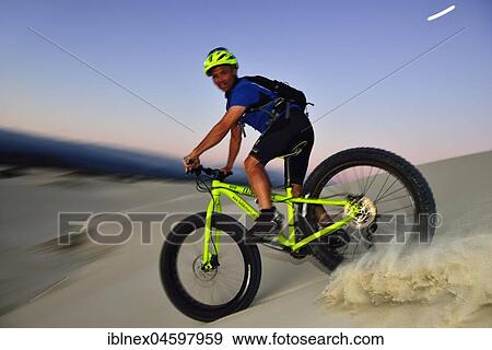 Stock Photo - Cyclist with Fatbike descending sand dune, Plaat Beach, Nature Reserve, De Kelders, Gansbaai, Western Cape, South Africa, Africa. Fotosearch