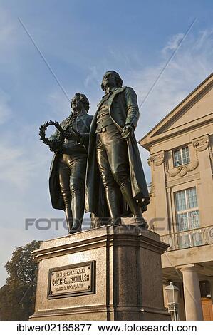Stock Photo - Deutsches Nationaltheater, German National Theater on Theaterplatz square, Goethe and Schiller monument in Weimar, Thuringia, Germany, Europe. Fotosearch