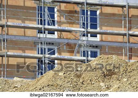 Earth bank in front of a scaffolded building under construction, apartment house, Ulm, Baden-Wuerttemberg, Germany, Europe, PublicGround, Europe View Large Photo Image Picture - Earth bank in front of a scaffolded building under construction, apartment house, Ulm, Baden-Wuerttemberg, Germany, Europe, PublicGround, Europe. Fotosearch