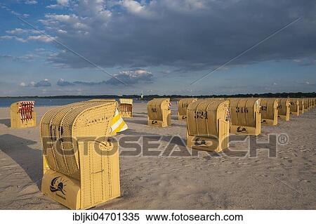 Stock Photography - Empty sandy beach with beach chairs, cloudy sky, Travemünde, Baltic Sea, Schleswig-Holstein, Germany, Europe. Fotosearch