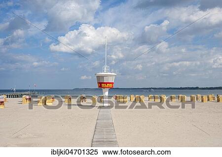 Stock Photography - Empty sandy beach with DLRG monitoring tower and beach chairs, Travemünde, Baltic Sea, Schleswig-Holstein, Germany, Europe. Fotosearch
