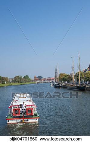 Excursion ship and Traditional sailing boat on the Untertrave, Lübeck, Schleswig-Holstein, Germany, Europe View Large Photo Image Stock Image - Excursion ship and Traditional sailing boat on the Untertrave, Lübeck, Schleswig-Holstein, Germany, Europe. Fotosearch