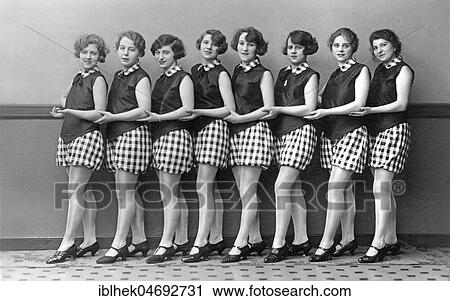 Stock Image - Fashion, eight women with the same shoes, tights, skirts and dresses, group portrait, 1920s, Germany, Europe. Fotosearch