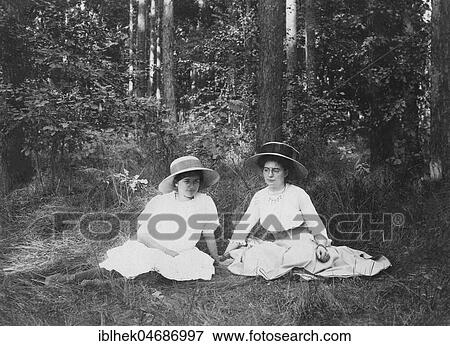 Fashion, summer outing, two women in summer clothes sitting in the forest, 1900s, Germany, Europe View Large Photo Image Stock Photo - Fashion, summer outing, two women in summer clothes sitting in the forest, 1900s, Germany, Europe. Fotosearch