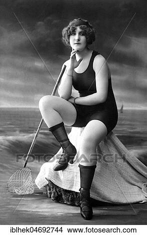 Fashion, swimwear, woman in swimsuit, shoes and stockings sitting by the sea, scenery, 1920s, Germany, Europe View Large Photo Image Picture - Fashion, swimwear, woman in swimsuit, shoes and stockings sitting by the sea, scenery, 1920s, Germany, Europe. Fotosearch