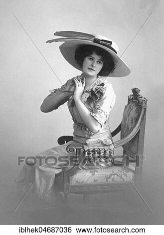 Stock Photograph - Fashion, woman in love in summer dress with rose and hat, 1900s, Germany, Europe. Fotosearch
