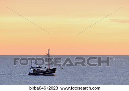 Fish trawler in the evening light on the North Sea, Norderney, East Frisian Islands, Lower Saxony, Germany, Europe View Large Photo Image Stock Image - Fish trawler in the evening light on the North Sea, Norderney, East Frisian Islands, Lower Saxony, Germany, Europe. Fotosearch