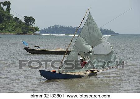 Stock Image - Fishing boat with improvised sails made from old plastic sheets, Limbe, Cameroon, Africa. Fotosearch