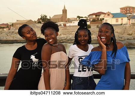 Stock Photo - Four young black women posing at the Waterfront, Lüderitz, Namibia, Africa. Fotosearch