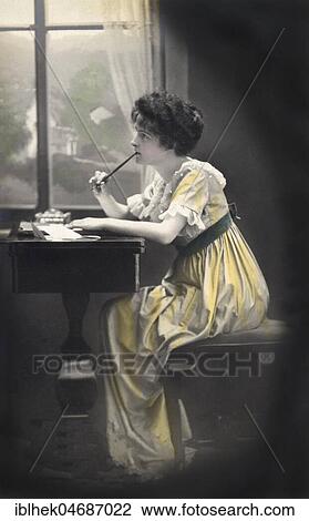 Stock Image - Frau thinks and writes a letter, 1910s, Germany, Europe. Fotosearch
