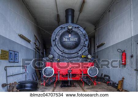 Picture - Freight train tender locomotive 94 1697, year of construction 1924, in repair in the locomotive shed, Bavarian Railway Museum Nördlingen, Nördlingen, Bavaria, Germany, Europe. Fotosearch
