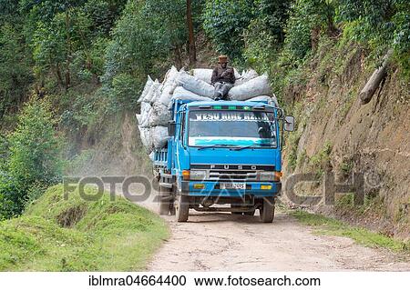 Stock Image - Fully loaded truck on sand road, Lake Mutanda, Uganda, Africa. Fotosearch