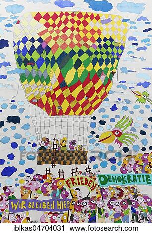 Stock Image - GDR citizens flee in a hot air balloon, mural on German Unity by Fischer-Art, Brühlarkade, Leipzig, Saxony, Germany, Europe. Fotosearch