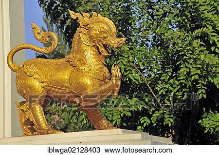Stock Image - Gilded lion, Singha, a guardian figure at the entrance of Wat Pho Chai temple, Nong Khai, Thailand, Asia, PublicGround, Asia. Fotosearch