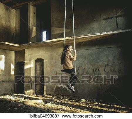Girl rocking on a swing in a destroyed building on the seafront in Okhamchira, Abkhazia, Georgia, Asia View Large Photo Image Stock Photo - Girl rocking on a swing in a destroyed building on the seafront in Okhamchira, Abkhazia, Georgia, Asia. Fotosearch