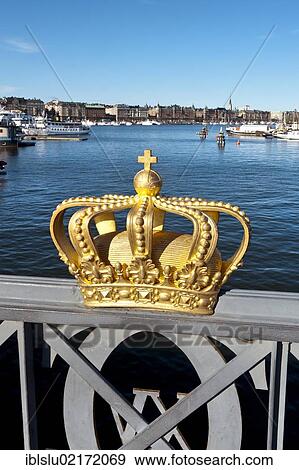 Stock Photo - Golden crown on Skeppsholmsbron bridge, view to Strandvaegen, Stockholm, Sweden, Scandinavia, Europe. Fotosearch