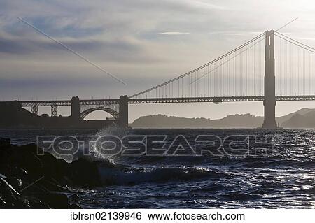 Golden Gate Bridge at night with splashing waves of San Francisco Bay in the foreground, San Francisco, California, USA, North America View Large Photo Image Stock Photograph - Golden Gate Bridge at night with splashing waves of San Francisco Bay in the foreground, San Francisco, California, USA, North America. Fotosearch