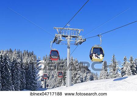 Stock Photo - Gondola lift in the Winklmoos-Alm ski area with gold medal gondola by Rosi Mittermaier, Reit im Winkl, Chiemgau, Bavaria. Fotosearch