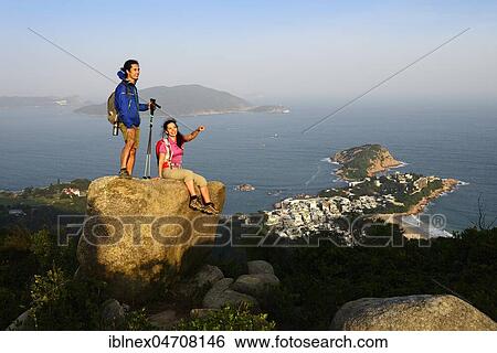 Hikers on rock, Dragons Back Trail, view on Shek O Bay, Hong Kong, China, Asia View Large Photo Image Stock Photograph - Hikers on rock, Dragons Back Trail, view on Shek O Bay, Hong Kong, China, Asia. Fotosearch
