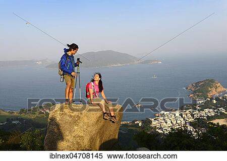 Hikers on rock, Dragons Back Trail, view on Shek O Bay, Hong Kong, China, Asia View Large Photo Image Stock Photography - Hikers on rock, Dragons Back Trail, view on Shek O Bay, Hong Kong, China, Asia. Fotosearch