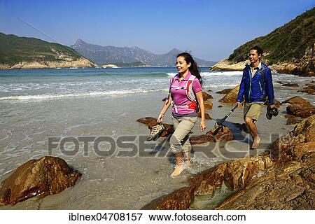 Stock Photo - Hikers on Sai Wan Beach, Big Wave Bay, also Tai Long Wan, Sai Kung Peninsula, New Territories, Hong Kong, China, Asia. Fotosearch