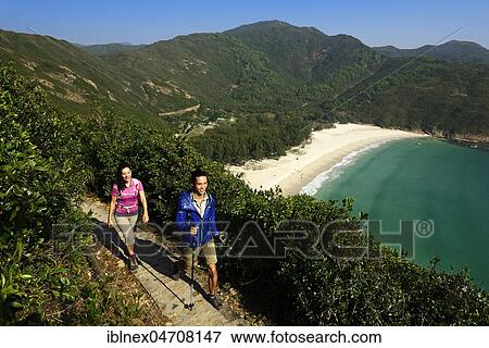 Stock Photo - Hikers on the McLehose Trail overlooking Long Ke Beach, Sai Kung Peninsula, New Territories, Hong Kong, China, Asia. Fotosearch