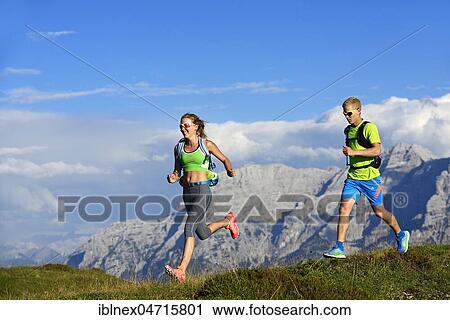 Stock Image - Hikers, Trail running on the Eggenalm, behind Loferer Steinberge, Reit im Winkl, Upper Bavaria, Bavaria, Germany, Europe. Fotosearch