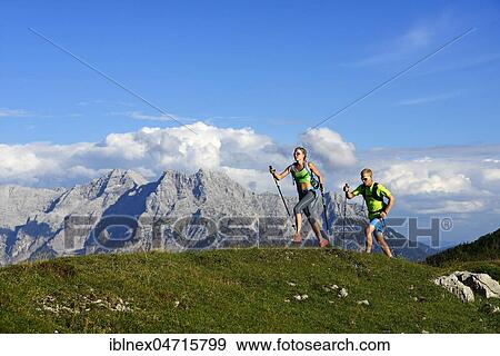 Stock Photo - Hikers, Trail running on the Eggenalm, behind Loferer Steinberge, Reit im Winkl, Upper Bavaria, Bavaria, Germany, Europe. Fotosearch