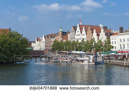 Stock Photo - Historic houses, excursion boats on the river Trave, Lübeck, Schleswig-Holstein, Germany, Europe. Fotosearch
