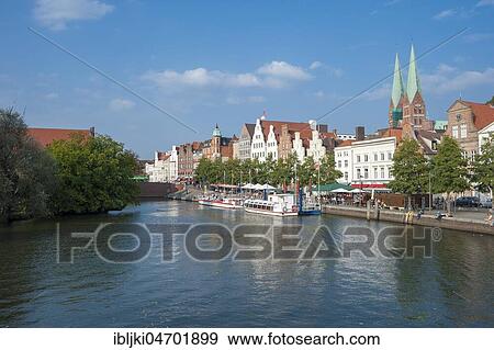 Stock Photo - Historic houses, excursion boats on the river Trave, Lübeck, Schleswig-Holstein, Germany, Europe. Fotosearch