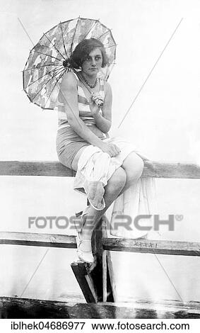 Holiday, woman with parasol and swimsuit at the jetty, 1930s, Usedom, Baltic Sea, Germany, Europe View Large Photo Image Stock Photo - Holiday, woman with parasol and swimsuit at the jetty, 1930s, Usedom, Baltic Sea, Germany, Europe. Fotosearch