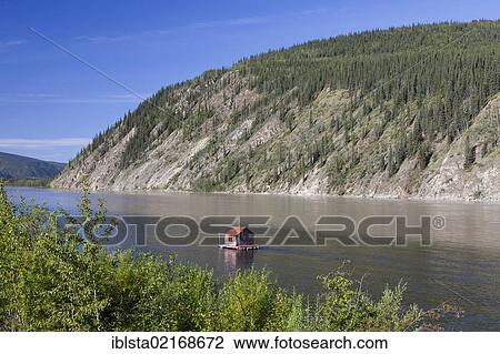 Stock Image - Houseboat on the Yukon River at Dawson City, Canada, North America. Fotosearch