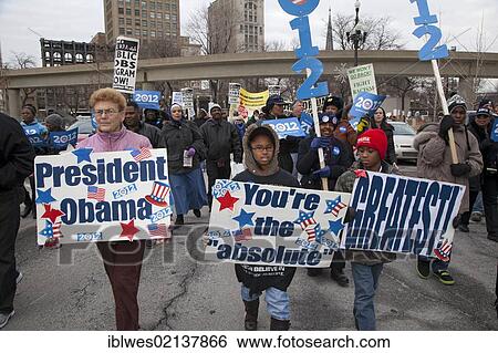 Stock Photograph - Hundreds of people marched for jobs, peace, and justice on the Martin Luther King Jr holiday, one group carried signs calling for the reelection of President Obama, Detroit, Michigan, USA, North America. Fotosearch