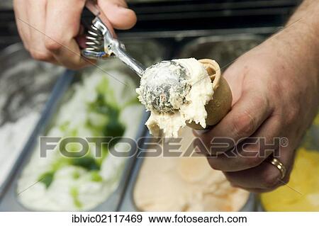 Ice-cream seller putting scoop of ice-cream on a cone, ice cream parlour, Rome, Italy, Europe View Large Photo Image Stock Photo - Ice-cream seller putting scoop of ice-cream on a cone, ice cream parlour, Rome, Italy, Europe. Fotosearch
