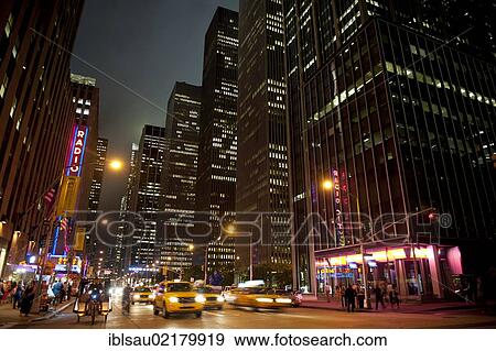 Illuminated skyscrapers and traffic at night, 6th Avenue corner of 51st West, Midtown, Manhattan, New York City, USA, North America View Large Photo Image Stock Photo - Illuminated skyscrapers and traffic at night, 6th Avenue corner of 51st West, Midtown, Manhattan, New York City, USA, North America. Fotosearch