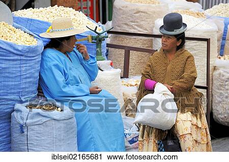 Stock Image - Indian woman with a stall by the side of the road, La Paz, Bolivia, South America. Fotosearch