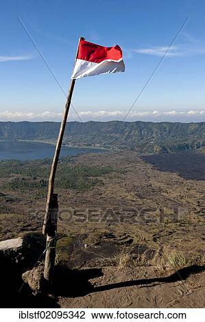 Stock Image - Indonesian flag raised on Mount Gunung Batur, Central Bali, Bali, Indonesia, Southeast Asia, Asia. Fotosearch