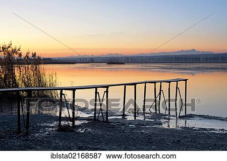 Stock Photo - Jetty on a winter morning with views of the avenue in Hegne on Reichenau Island, Baden-Wuerttemberg, Lake Constance, Germany, Europe. Fotosearch
