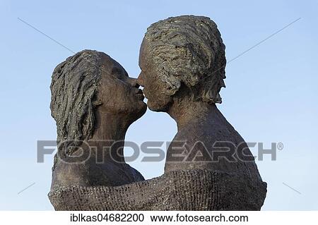 Kissing couple, bronze sculpture by Belgian sculptor Linde Ergo, De Haan, West-Flanders, Belgium, Europe View Large Photo Image Stock Image - Kissing couple, bronze sculpture by Belgian sculptor Linde Ergo, De Haan, West-Flanders, Belgium, Europe. Fotosearch