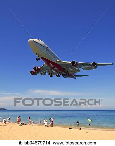 Picture - Landing approach over sandy beach, Mai Kao Beach, Phuket, Thailand, Asia. Fotosearch